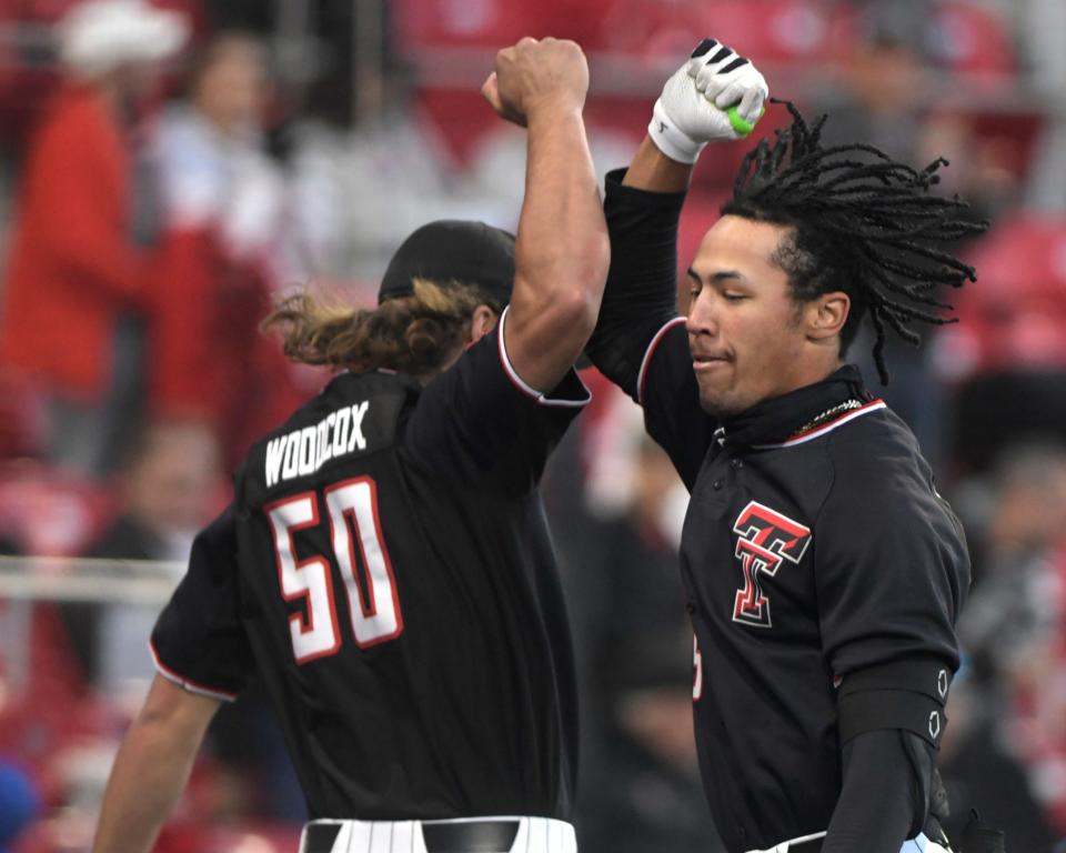 Texas Tech outfielder Drew Woodcox, left, and infielder T.J. Pompey, right, celebrate a Pompey home run in an April 1 victory against Stanford. Woodcox and Pompey homered twice apiece Wednesday night to help Tech win 21-3 at Abilene Christian.