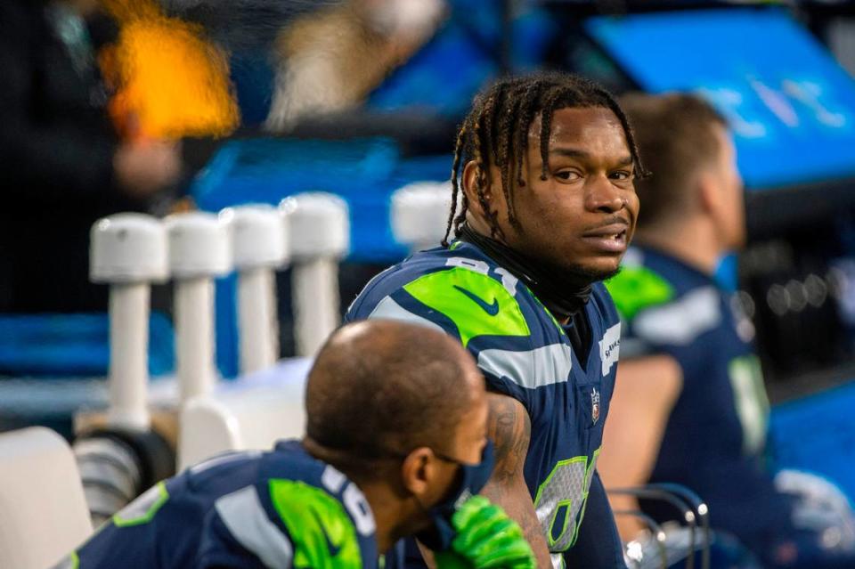 Seattle Seahawks tight end Gerald Everett (81) looks over at wide receiver Tyler Lockett (16) on the bench as the Arizona Cardinals close out the game in the fourth quarter of an NFL game on Sunday afternoon at Lumen Field in Seattle.