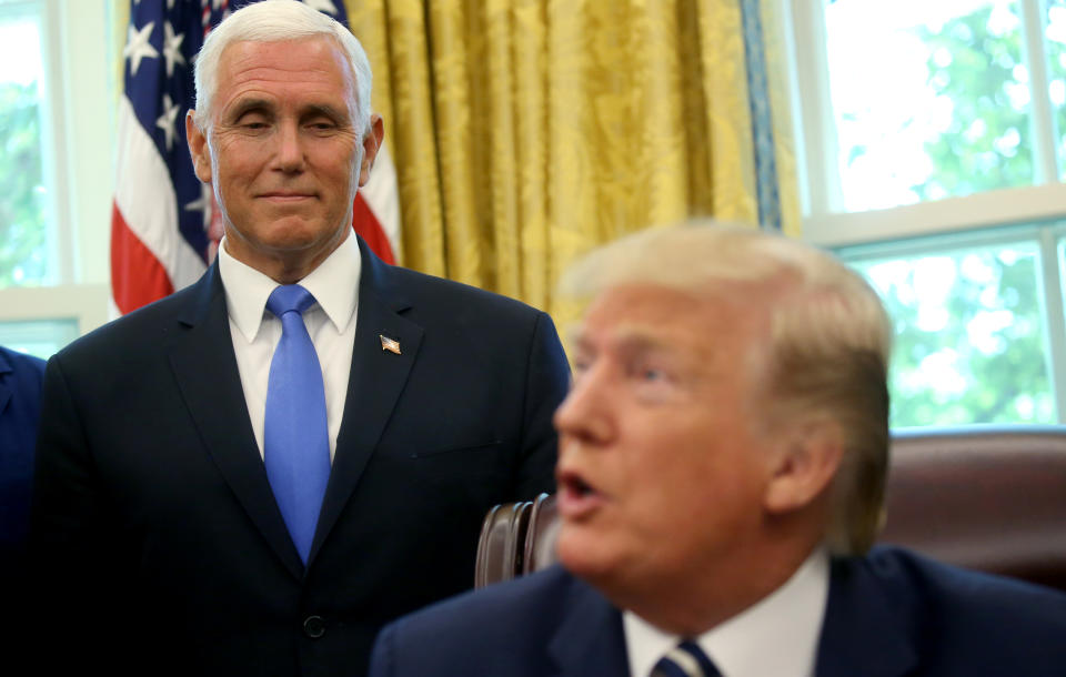 ?Vice President Mike Pence? watches U.S. President Donald Trump as Trump acknowledges former astronauts and their family members during an Apollo 11 moon landing 50th anniversary commemoration in the Oval Office of the White House in Washington, U.S., July 19, 2019. REUTERS/Leah Millis