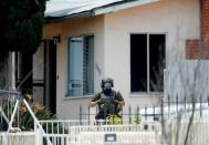 A police SWAT team member leaves a home they had surrounded while searching for a second suspect after a San Diego police officer was fatally shot and another was wounded late on Thursday, in San Diego, California, United States July 29, 2016. REUTERS/Mike Blake