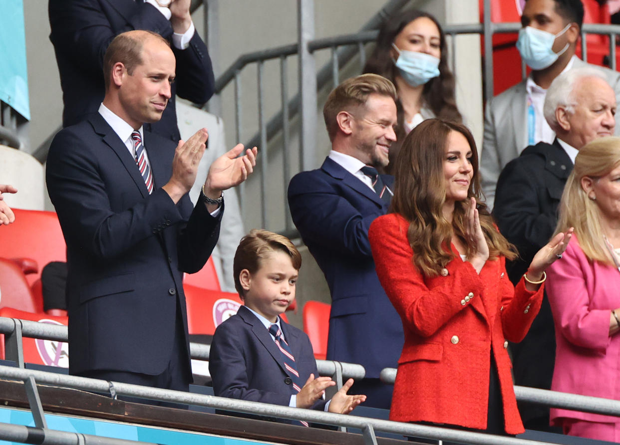 29 June 2021, United Kingdom, London: Football: European Championship, England - Germany, final round, round of 16 at Wembley Stadium. The British Prince William, Duke of Cambridge stands with his wife Kate, Duchess of Cambridge, and their son Prince George in the stands. Photo: Christian Charisius/dpa (Photo by Christian Charisius/picture alliance via Getty Images)