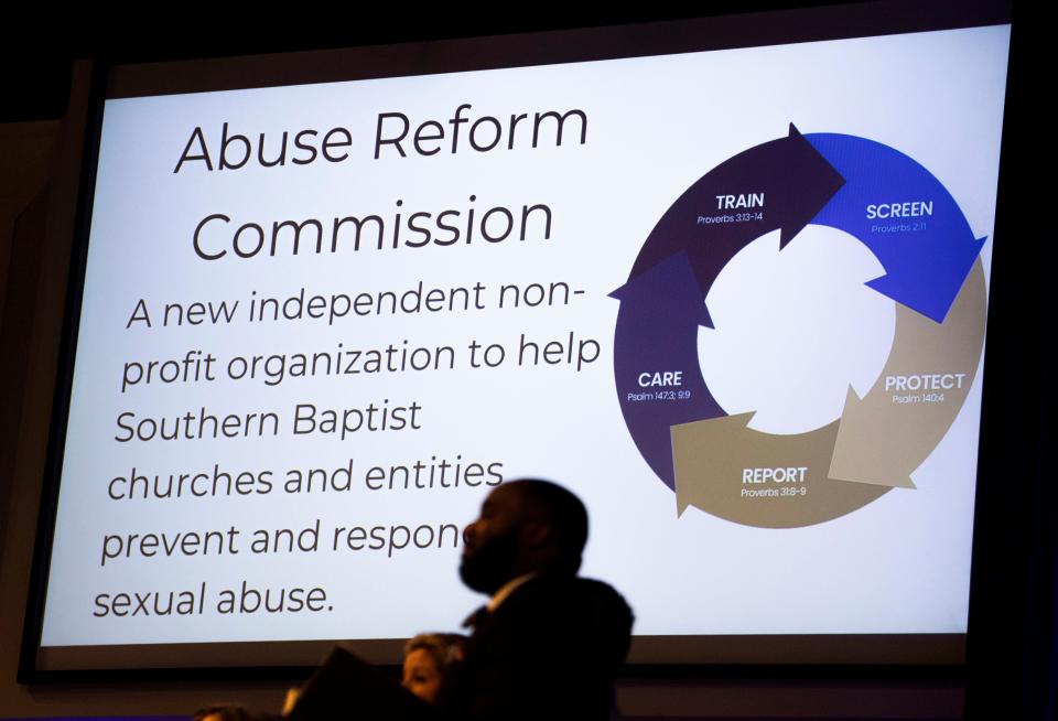 A slide show presentation is projected on the screens as the Rev. Josh Wester, chairman of the Southern Baptist Convention's Abuse Reform Implementation Task Force, speaks during the SBC Executive Committee meeting in February at the SBC building in Nashville.