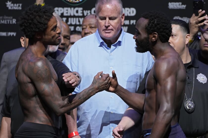 Errol Spence Jr., left, and Terence Crawford shake hands during a weigh-in Friday in Las Vegas