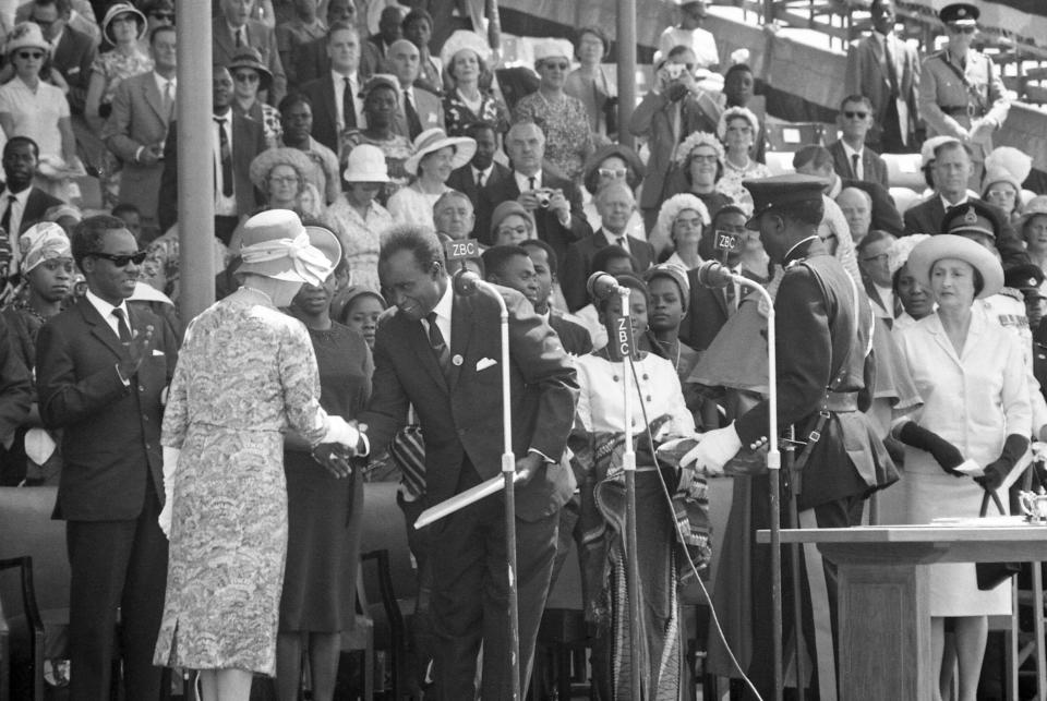 FILE - In this Oct. 24, 1964 file photo, Britain's Mary, The Princess Royal, representing the Queen Elizabeth II, hands over the Instruments of Independence to President Kenneth Kaunda during the Zambia Independence Ceremony in Luksaka. The new African Republic of Zambia was formerly known as Northern Rhodesia. Zambia’s first president Kenneth Kaunda has died at the age of 97, the country's president Edward Lungu announced Thursday June 17, 2021. (AP Photo/Dennis-Lee Royle, File)