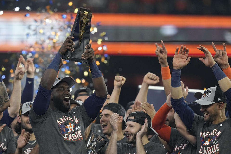 Houston Astros designated hitter Yordan Alvarez holds the trophy after their win against the Boston Red Sox in Game 6 of baseball's American League Championship Series Friday, Oct. 22, 2021, in Houston. The Astros won 5-0, to win the ALCS series in game six. (AP Photo/Tony Gutierrez)