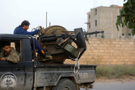 A member of the Libyan internationally recognised government forces fires during fighting with Eastern forces in Ain Zara, Tripoli, Libya April 20, 2019. REUTERS/Hani Amara