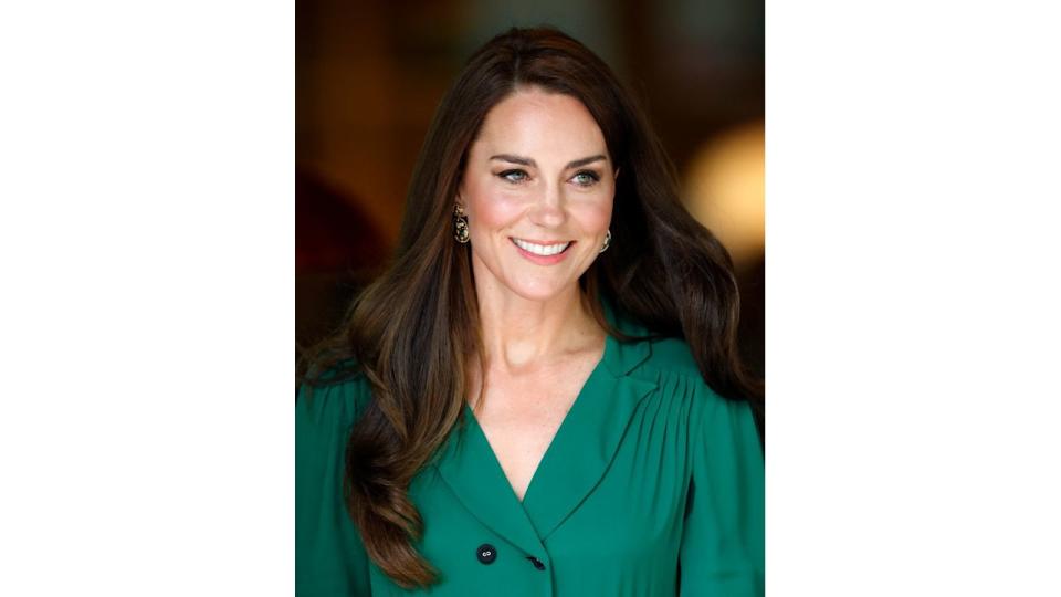 Kate Middleton wearing green dress and smiling