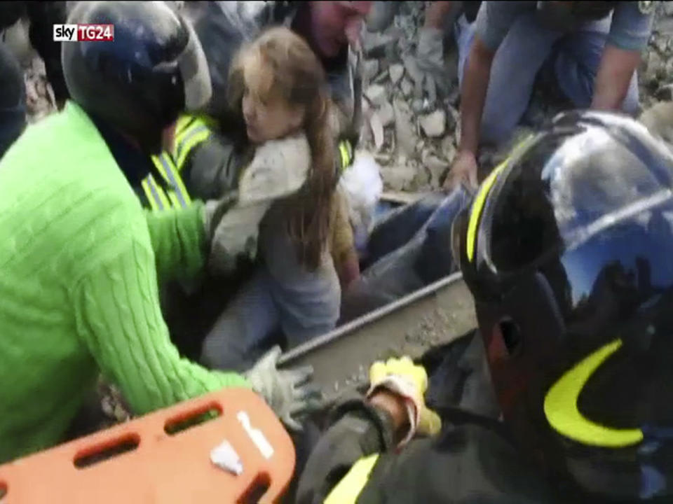 <p>In this image taken from a video, a 10-year-old girl is pulled alive from the rubble following an earthquake in Pescara Del Tronto, Italy, Wednesday, Aug. 24, 2016. (Sky Italia via AP) </p>