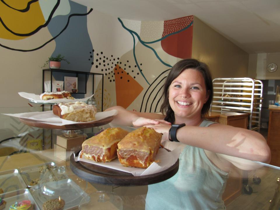 Brittani Hoffman stands behind her orange pound cake and cinnamon roll at her new bakery, Tudie's Cookies & Sweets, 3009 N. High St. in Clintonville.