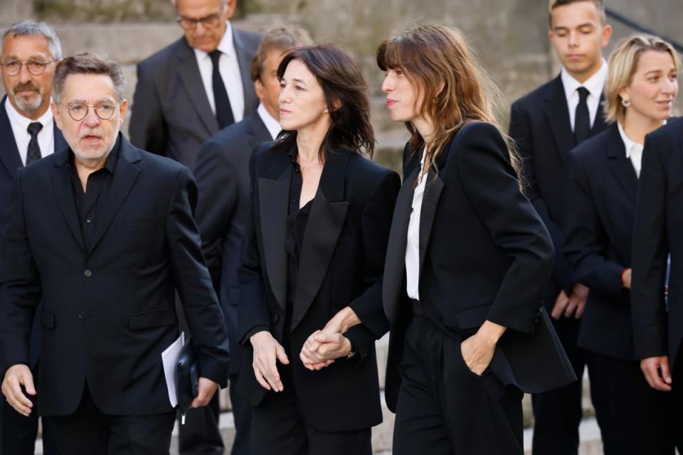 Jane Birkin’s daughters Charlotte Gainsbourg, center, and Lou Dillon, center right, arrive at Jane Birkin’s funerals ceremony (AP)