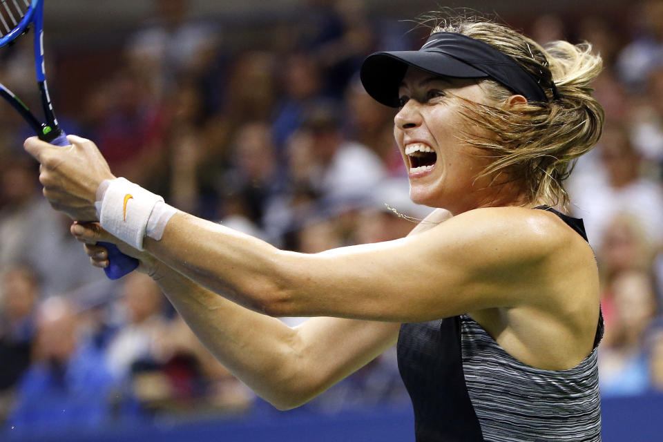 Maria Sharapova, of Russia, returns a shot to Carla Suarez Navarro, of Spain, during the fourth round of the U.S. Open tennis tournament, Monday, Sept. 3, 2018, in New York. (AP Photo/Jason DeCrow)