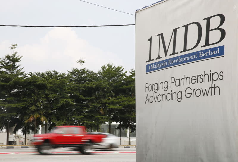 Traffic passes a 1MDB billboard in Kuala Lumpur in 2015. (File photo: Reuters/Olivia Harris)