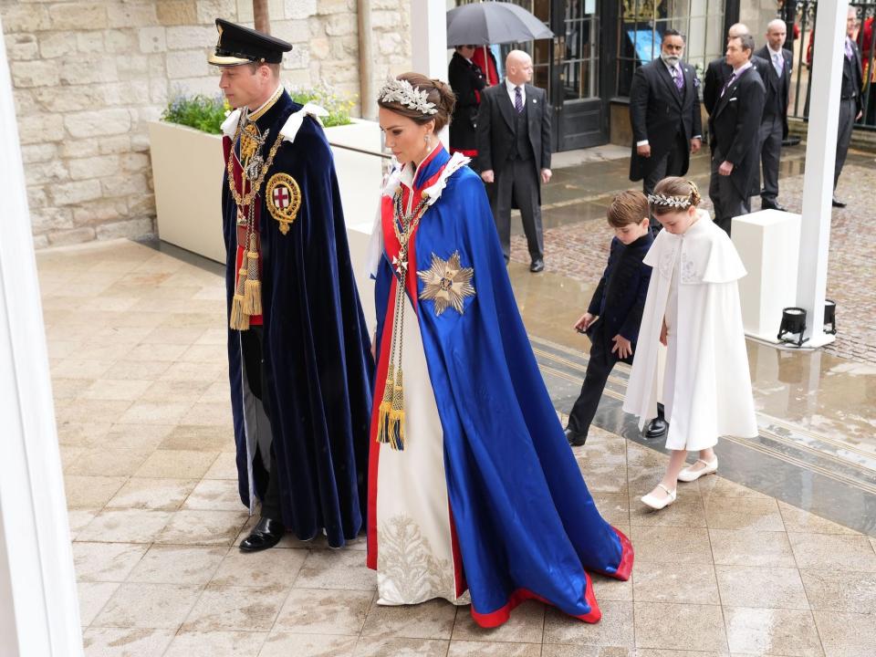 Prince William, Kate Middleton, Prince Louis, and Princess Charlotte process into King Charles III's coronation.