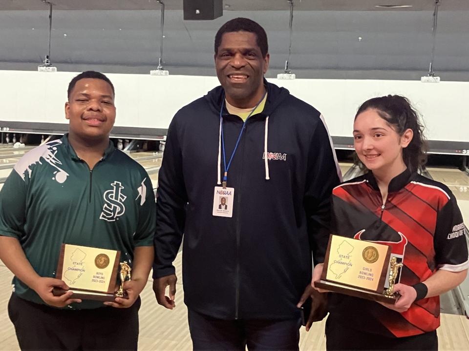 NJSIAA individual bowling finals at Bowlero North Brunswick on Thursday, Feb. 29, 2024. Boys champion Kai Strothers of St. Joseph-Metuchen and girls champion Amelia Lemanowicz of Morris Tech accept their trophies from NJSIAA Director of Bowling Derryk Sellers.
