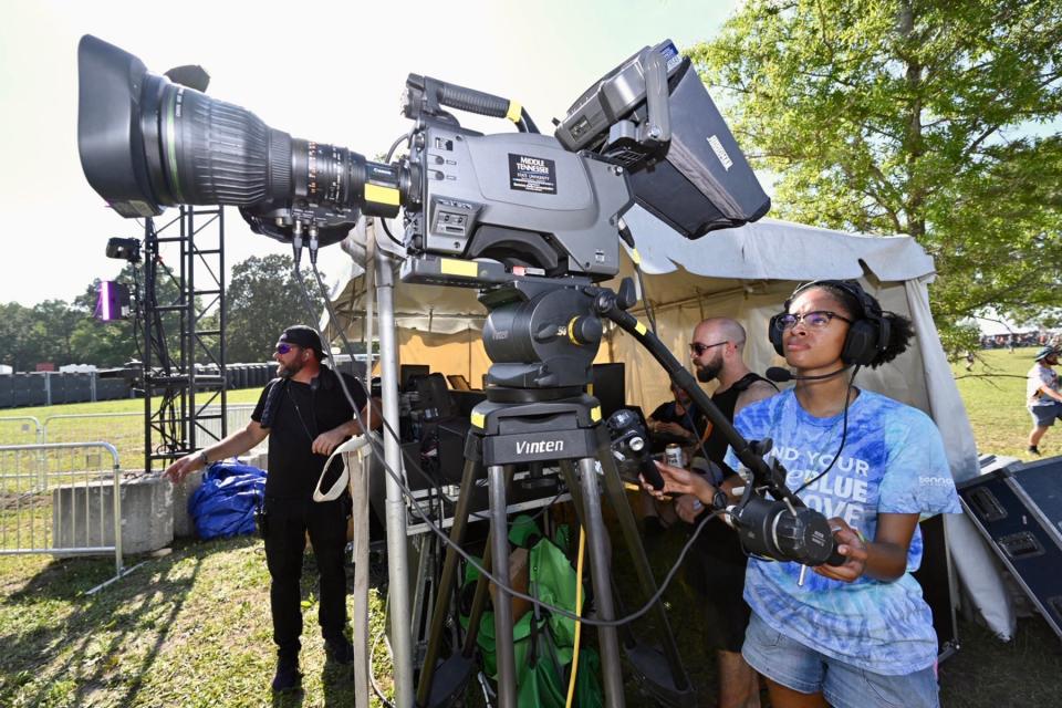 MTSU senior Kayla Bradshaw, right, a video and film production major from Lexington, S.C., films a performance Friday, June 17, at the 2022 Bonnaroo Music and Arts Festival being held June 16-19 in Manchester, Tenn. Bradshaw and other students are working at the festival as part of the university’s ongoing partnership with the event to provide College of Media and Entertainment students with real-world experience.
