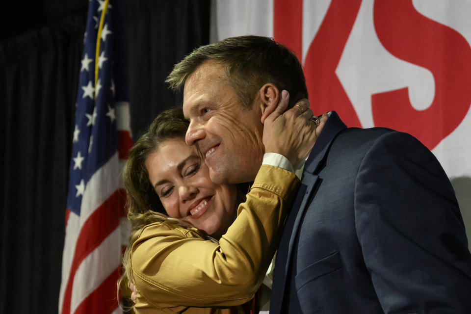 Kris Kobach, Republican candidate for attorney general of Kansas, hugs his wife, Heather, after speaking at a Republican watch party in Topeka, Kan., Tuesday, Nov. 8, 2022. (AP Photo/Reed Hoffmann)