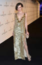 <b>Who:</b> Milla Jovovich <br><b>What:</b> Gold Prada gown <br><b>Where:</b> De Grisgono party <br><b>Why We Love It:</b> Surprise! It's another entry into the Best Thigh-High Slits of Cannes category. Jovovich glows in this plunging Prada. The actress' side-swept bob shows off her drop earrings beautifully, adding drama to a V-neck framed by extra-large spangles. Photo by Getty Images