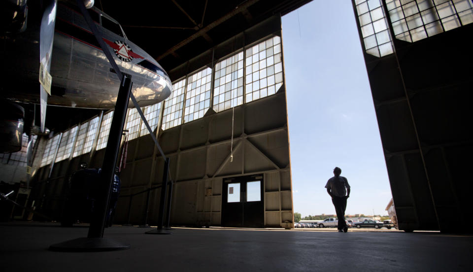 In this Friday, Sept. 20, 2013 photo, an airport chaplain tours a hanger at Delta Air Lines headquarters while attending the International Association of Civil Aviation Chaplains' annual conference, in Atlanta. Airports are mini-cities with their own movie theaters, fire departments and shopping malls. Many also have chapels, which are staffed by a mix of 350 part- and full-time chaplains worldwide who are Catholic, Protestant and, to a lesser extent, Jewish, Muslim or Sikh. (AP Photo/David Goldman)