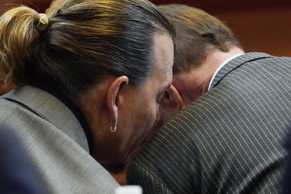 Actor Johnny Depp talks to attorney Ben Chew in the courtroom at the Fairfax County Circuit Courthouse in Fairfax, Va., Monday, May 16, 2022. Depp sued his ex-wife Amber Heard for libel in Fairfax County Circuit Court after she wrote an op-ed piece in The Washington Post in 2018 referring to herself as a "public figure representing domestic abuse." (AP Photo/Steve Helber, Pool)