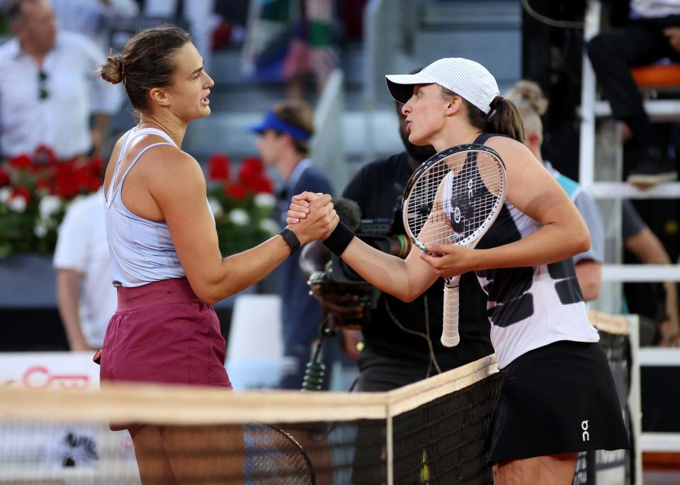 Iga Swiatek (right) shakes hands with world No. 2 Aryna Sabalenka after their matchup in the 2023 Madrid Open final.