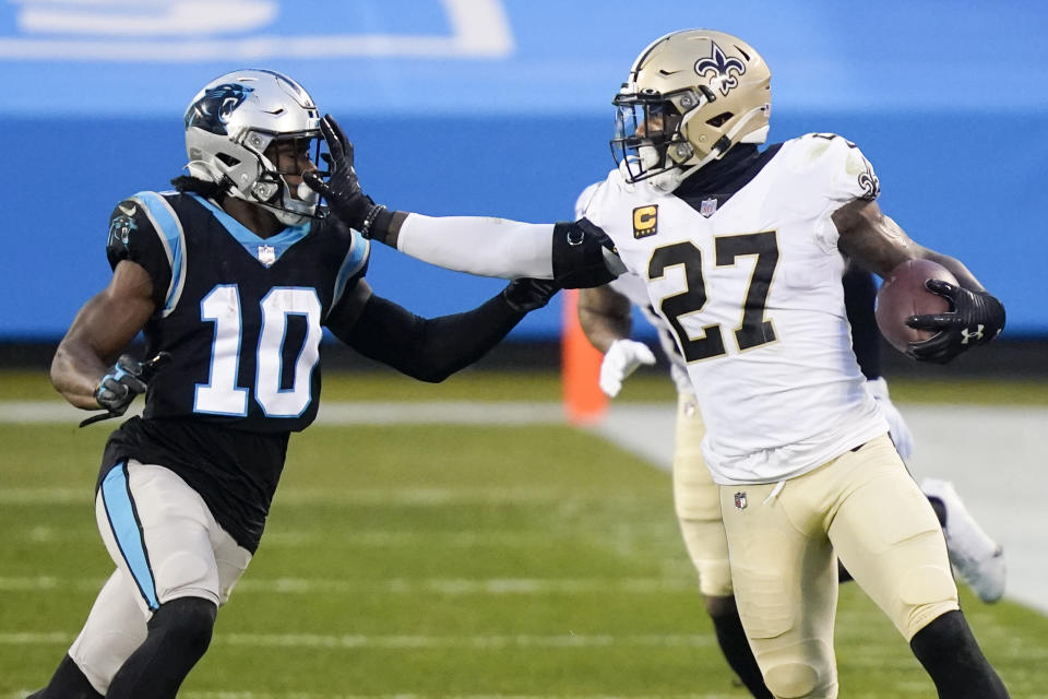 New Orleans Saints strong safety Malcolm Jenkins runs around Carolina Panthers wide receiver Curtis Samuel during the first half of an NFL football game Sunday, Jan. 3, 2021, in Charlotte, N.C. (AP Photo/Gerry Broome)