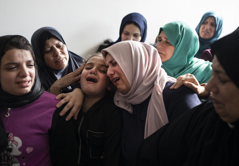 Relatives of Islamic Jihad commander, Bahaa Abu el-Atta, who was killed with his wife by an Israeli missile strike that hit their home, mourn in the family home during his funeral in Gaza City, Tuesday, Nov. 12, 2019. (AP Photo/Khalil Hamra)