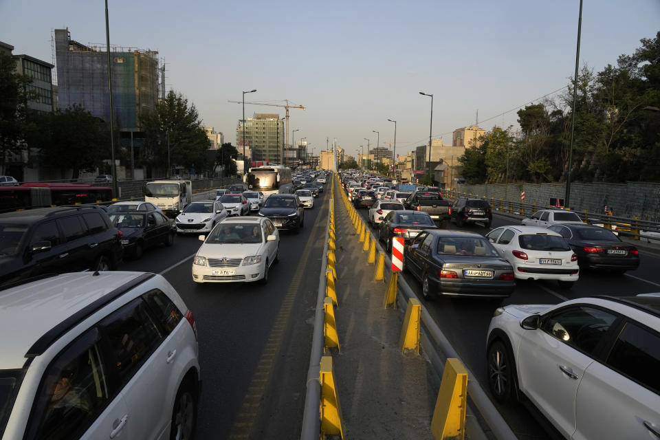 People commute in their cars during an afternoon traffic jam in northern Tehran, Iran, Tuesday, July 2, 2024. Comments suggesting that Iran's reformist presidential candidate could increase government-set gasoline prices have raised fears of a repeat of nationwide protests. (AP Photo/Vahid Salemi)