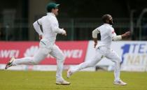 Cricket - Sri Lanka v South Africa -Second Test Match - Colombo, Sri Lanka - July 20, 2018 - South Africa's Temba Bavuma (R) and Dean Elgar run to stop the ball hit by Sri Lanka's Danushka Gunathilaka (not pictured). REUTERS/Dinuka Liyanawatte