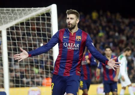 Barcelona's player Gerard Pique celebrates a goal against Cordoba during their Spanish First division soccer match at Camp Nou stadium in Barcelona December 20, 2014. REUTERS/Albert Gea