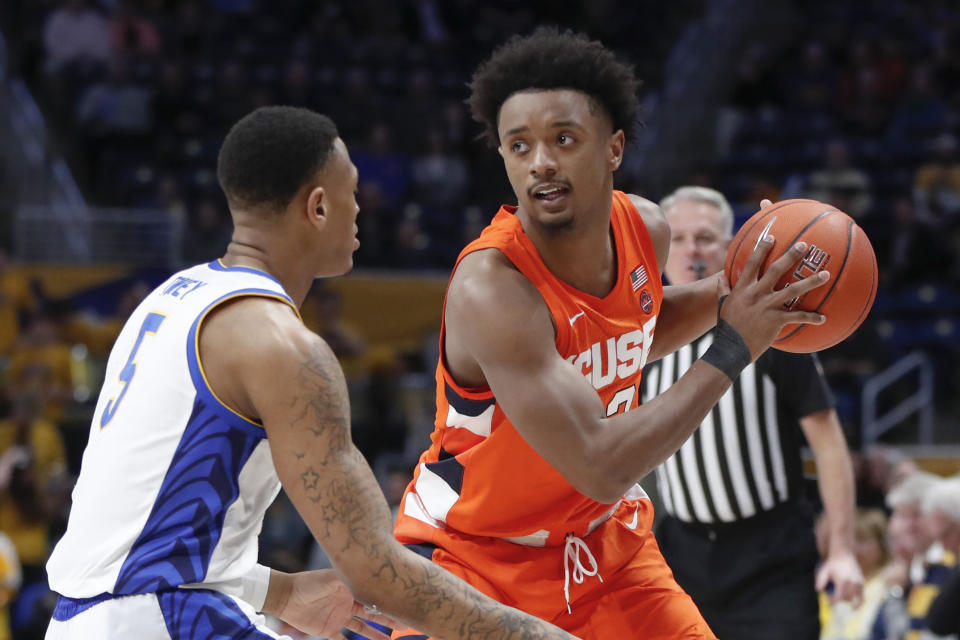 Syracuse's Elijah Hughes, right, looks to pass around Pittsburgh's Au'Diese Toney (5) during the first half of an NCAA college basketball game, Wednesday, Feb. 26, 2020, in Pittsburgh. Syracuse won 72-49.(AP Photo/Keith Srakocic)