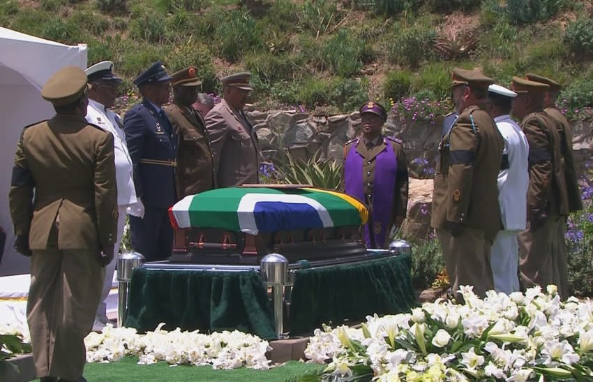 Military personnel stand beside coffin of former South African President Mandela at burial site in ancestral village of Qunu