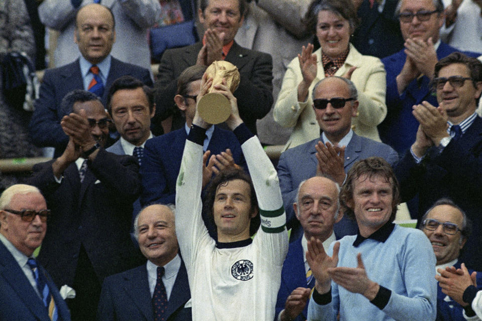 FILE - West Germany captain, Franz Beckenbauer holds up the World Cup trophy after his team defeated the Netherlands 2-1, in the World Cup final soccer match at Munich's Olympic stadium, in West Germany on July 7, 1974. (AP Photo/File)