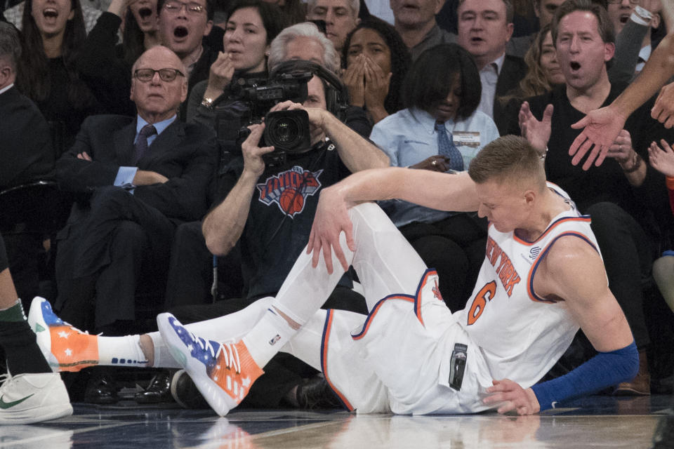 Knicks forward Kristaps Porzingis clutches his knee in the first half Tuesday night. (AP)