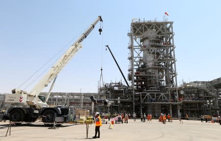 Workers are seen at the damaged site of Saudi Aramco oil facility in Khurais