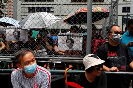 People hold placards at a protest in Hong Kong