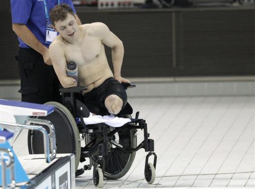 Lyndon Longhorne gets into his wheelchair after breaking the British record for his S4 class and securing his qualification for the 2012 London Paralympics after the multi classification men's 150m individual medley final at the British Gas Swimming Championships 2012 at the Olympic Aquatics Centre in London March 8, 2012.