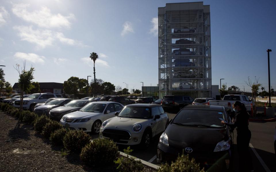row of pre-registered cars at auto delaership - Patrick Fallon/Bloomberg