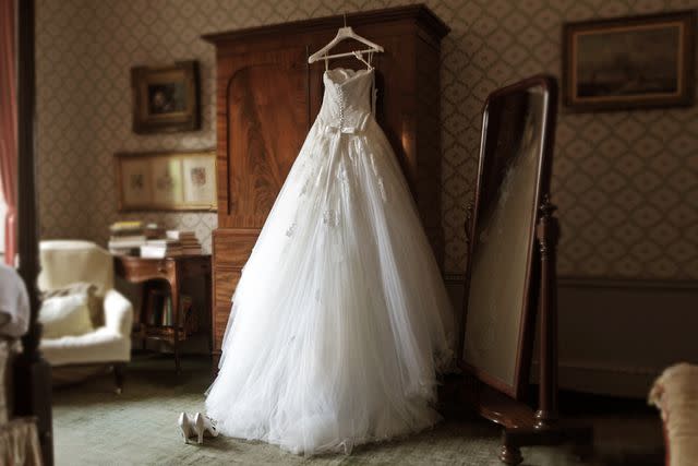 <p>Getty</p> A wedding dress hanging in a room