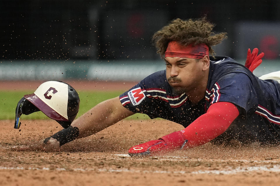 Cleveland Guardians' Josh Naylor slides head first into first base to score in the sixth inning of a baseball game against the Chicago White Sox, Tuesday, July 2, 2024, in Cleveland. (AP Photo/Sue Ogrocki)