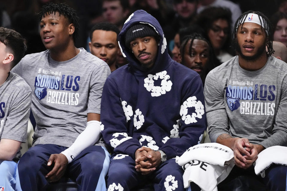 Memphis Grizzlies' Ja Morant, center, watches with teammates during the first half of an NBA basketball game against the Brooklyn Nets, Monday, March 4, 2024, in New York. (AP Photo/Frank Franklin II)