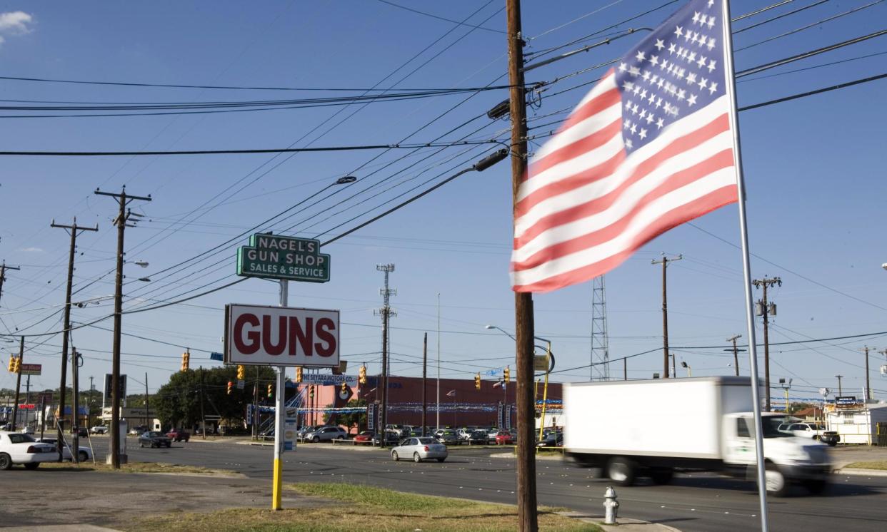 <span>A sign indicates Nagel's Gun Shop, in San Antonion, Texas, near the 2,000 miles long U.S.-Mexico border.</span><span>Photograph: Gilles Mingasson/Getty Images</span>