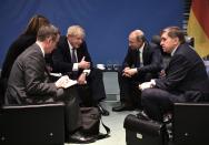 British Prime Minister Boris Johnson, center left, and Russian President Vladimir Putin, second right, talk to each other during their meeting on the sideline of a conference on Libya at the chancellery in Berlin, Germany, Sunday, Jan. 19, 2020. German Chancellor Angela Merkel hosts the one-day conference of world powers on Sunday seeking to curb foreign military interference, solidify a cease-fire and help relaunch a political process to stop the chaos in the North African nation. (Alexei Nikolsky, Sputnik, Kremlin Pool Photo via AP)