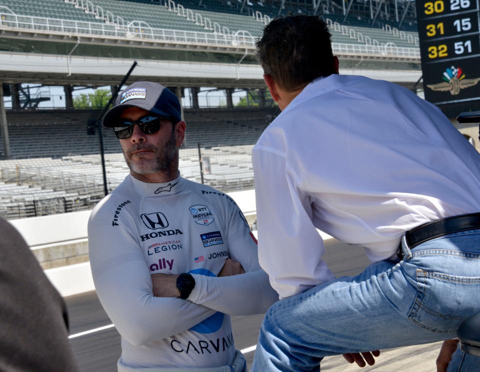 Chip Ganassi Racing driver Jimmie Johnson (48) talks with Scott Pruett on Tuesday, May 17, 2022, during the first day of Indianapolis 500 practice at Indianapolis Motor Speedway. 