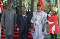 Omar Touray, president of the ECOWAS Commission, left, Ghana's President, Nana Akufo Addo, center and Nigeria Minister of Foreign Affairs, Yusuf Tuggar pose for a photo, prior to the start of the ECOWAS meeting, in Abuja, Nigeria, Saturday, Feb. 24, 2024. Heads of state across West Africa were meeting on Saturday to discuss the region's existential challenges with a renewed plea on junta-led nations to rescind their decision to quit the regional bloc and a plan to review of sanctions it imposed to reverse the coup in Niger. (AP Photo/Gbemiga Olamikan)