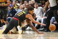 Atlanta Hawks guard Trae Young (11) and Indiana Pacers forward T.J. Warren battle for the ball during the final moments of an NBA basketball game Saturday, Jan. 4, 2020, in Atlanta. (AP Photo/John Amis)