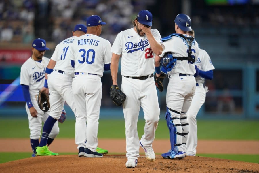 Los Angeles Dodgers starting pitcher Clayton Kershaw, center, reacts as he exits during the first inning in Game 1 of a baseball NL Division Series against the Arizona Diamondbacks, Saturday, Oct. 7, 2023, in Los Angeles. (AP Photo/Ashley Landis)