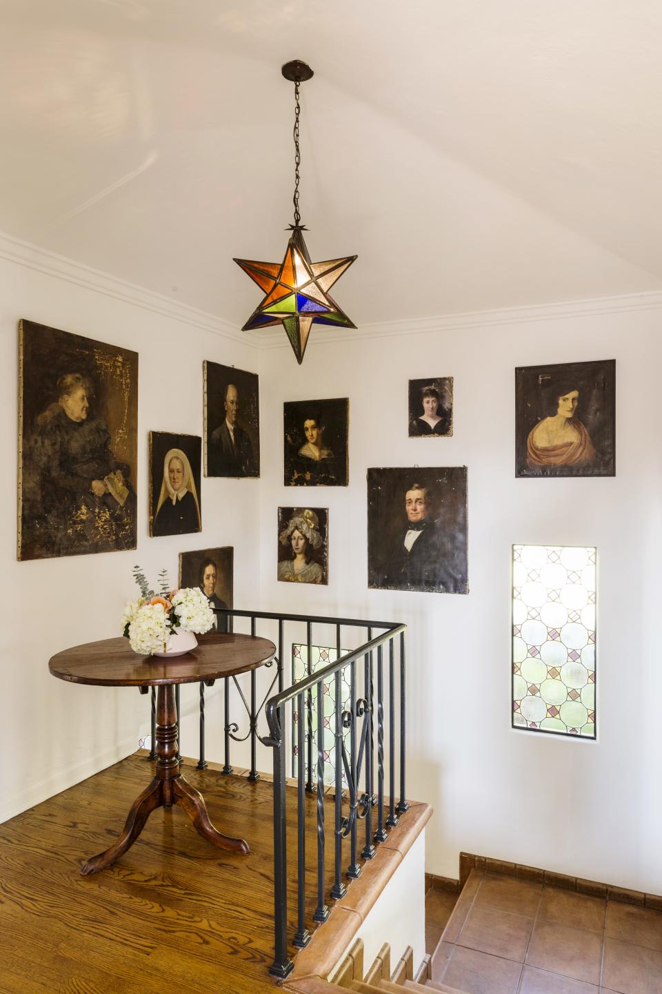 The portrait gallery at the top of the stairwell has been assembled from diverse sources: Paul’s parents, antique stores, and a Paris flea market. “These are all our ancestors,” Aniello jokes. “Welcome to our little Hogwarts home,” Downs adds.