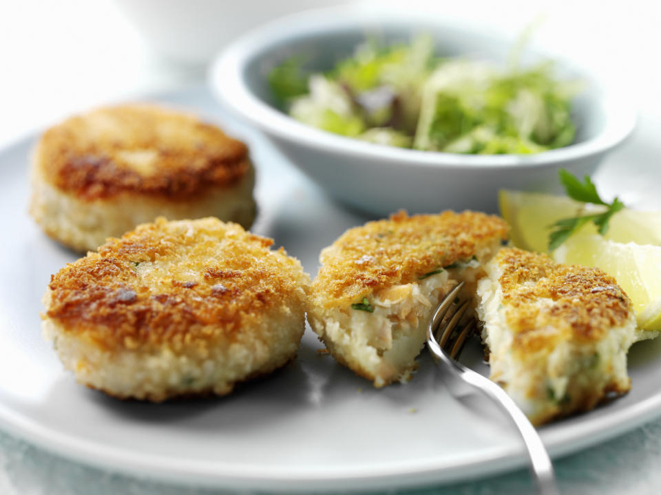Fish cakes on a plate with a side salad.