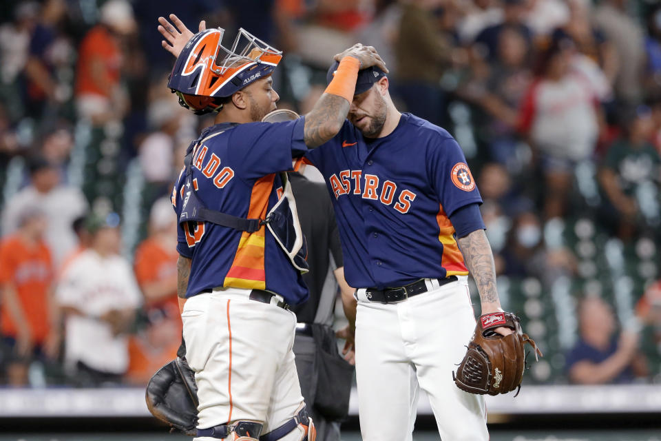 Houston Astros catcher Martin Maldonado, left, and closing pitcher Ryan Pressly, right, pat each other on the head after their 3-1 win over the Los Angeles Angels after a baseball game Sunday, Sept. 12, 2021, in Houston. (AP Photo/Michael Wyke)