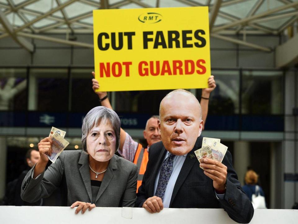 Members of the Rail, Maritime and Transport union protest train fare hikes outside Kings Cross (PA)